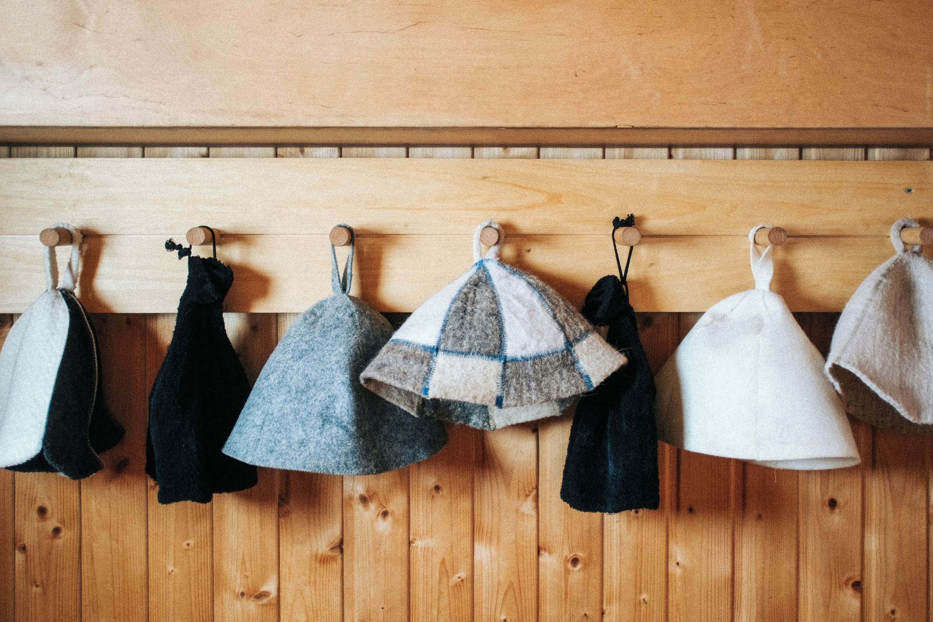 Sauna hats hanging on hooks
